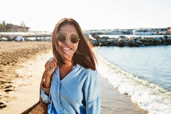 Woman on beach wearing sunspecs